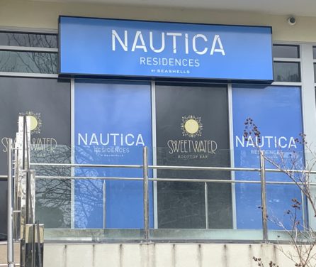 Sign on building saying Nautica Residences by Seashells