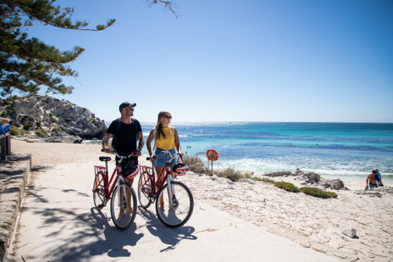 REX-Bike Hire-Couple walking with bikes next to beach_1920 Rottnest Express day trip